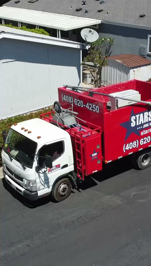 An aerial view of a Stars Junk Removal truck loaded with various items, ready for transport in San Jose, CA