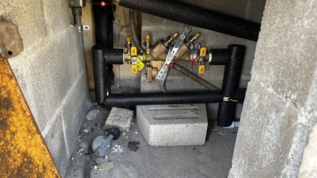 A backflow prevention device and insulated pipes installed by Economy Plumbing Services in Austin, TX