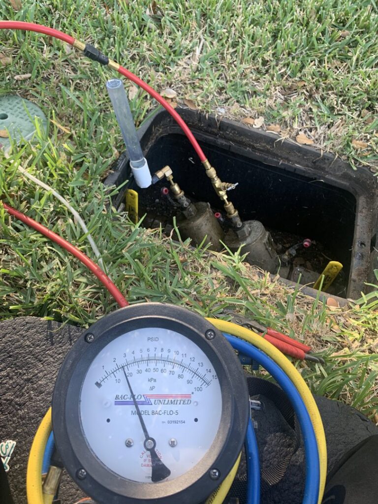 A backflow preventer being tested with a gauge, a service provided by The Bearded Plumber in San Antonio, TX.