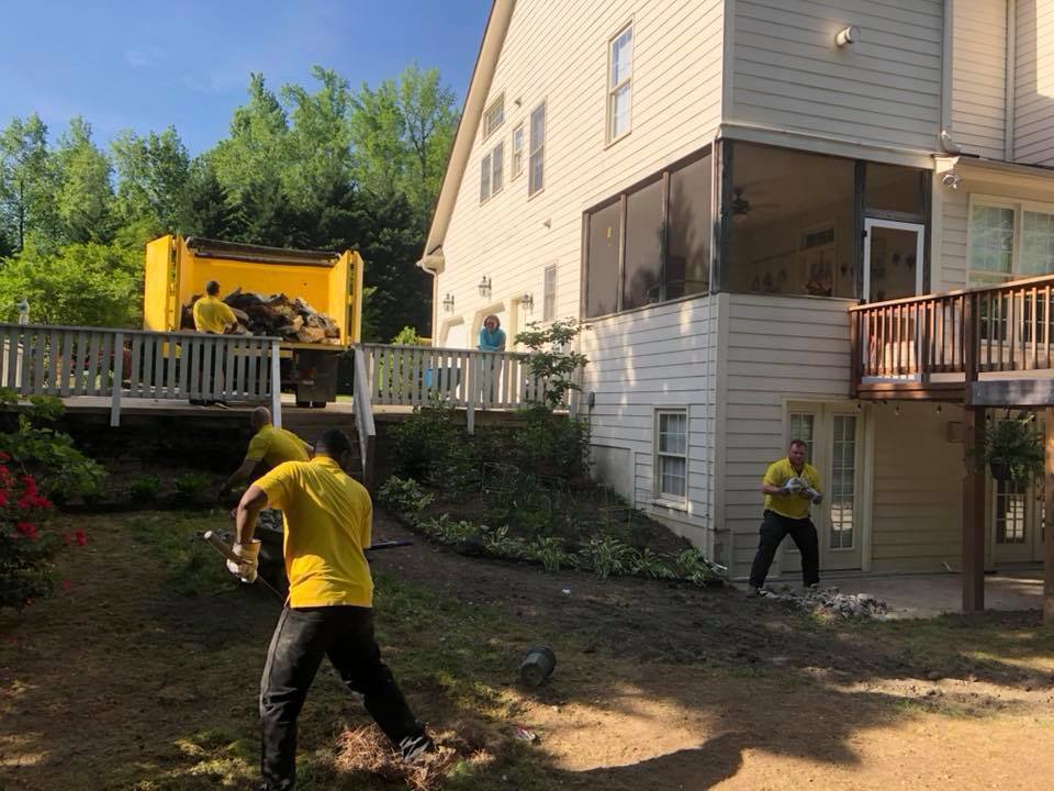 A Junk Doctors of Charlotte crew removing backyard debris and loading it into a truck in Charlotte, NC.