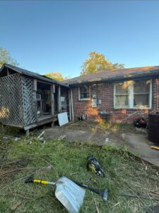 A backyard filled with debris and an old structure, ready for a yard cleanout by Clutch City Junk Removal in Tomball, TX.