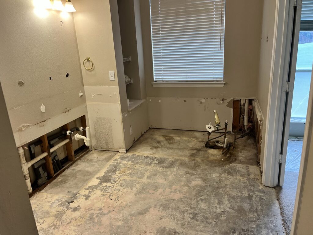 An interior bathroom after demolition, showing debris ready for removal by Hud's Haul Away Junk Removal & Demolition in Fort Worth, TX.