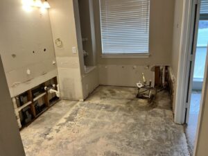 An interior bathroom after demolition, showing debris ready for removal by Hud's Haul Away Junk Removal & Demolition in Fort Worth, TX.