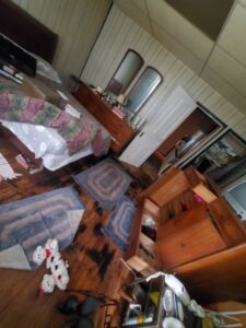 A cluttered bedroom before a cleanout service by Space Erasers Junk Removal in Philadelphia, PA