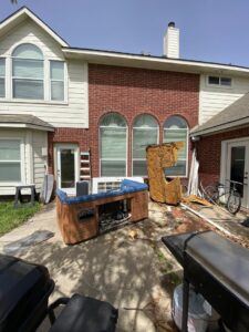 A broken hot tub and other debris in a backyard, ready for general junk removal by Get Junk Help in Houston, TX.