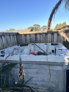 A broken hot tub in a backyard, ready for removal by Johan's Junk Removal and Hauling in San Diego, CA.