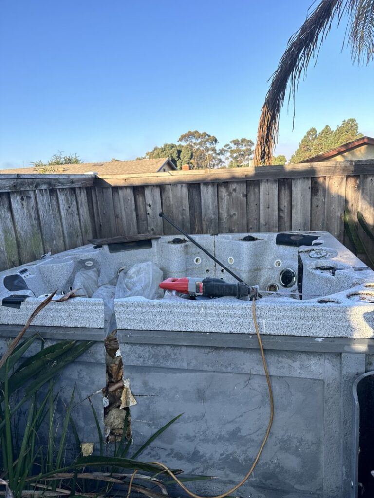 A broken hot tub in a backyard, ready for removal by Johan's Junk Removal and Hauling in San Diego, CA.