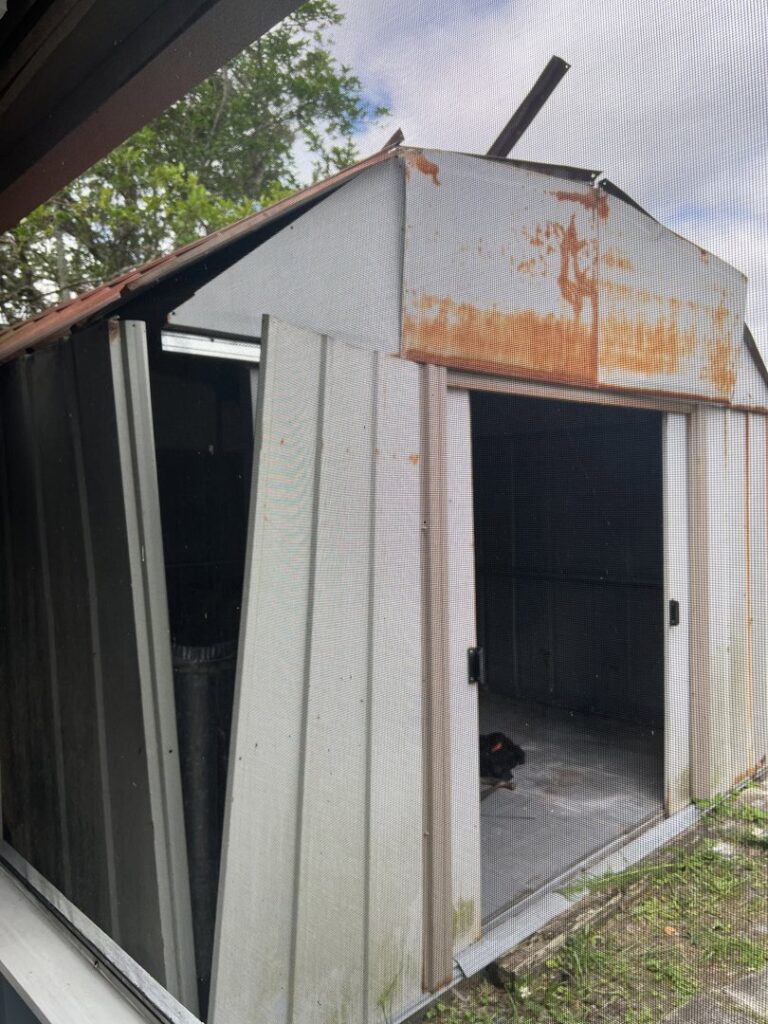 A large pile of flattened cardboard boxes ready for removal from a residential area by Junk Fade Away, LLC in Jacksonville, FL.