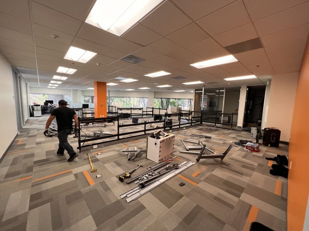 A pile of cardboard boxes and packaging materials on a driveway, awaiting junk removal by Zero Junk in San Jose, CA.