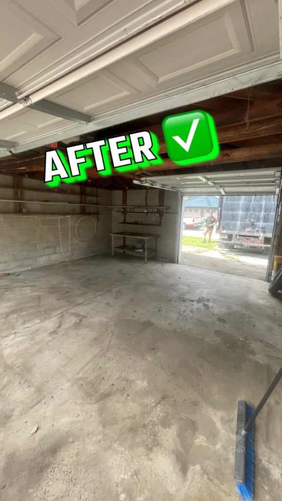 A clean and empty garage after a successful junk removal service by Junkzilla in Indianapolis, IN, with a truck visible in the background