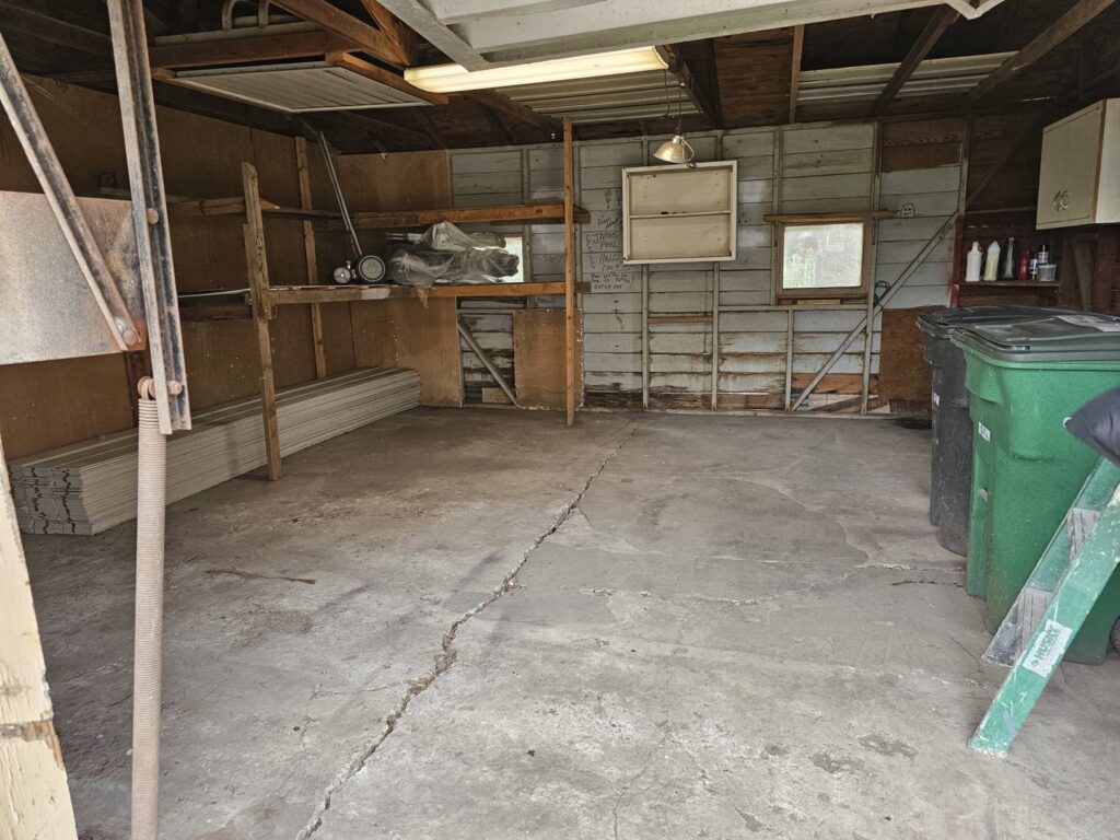 A clean and cleared garage after a junk removal service by 2 Bald Guys Hauling & Junk Removal in San Antonio, TX.