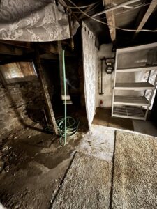 A cluttered basement area needing a cleanout service from GEF Hauling and Junk Removal in Philadelphia, PA.