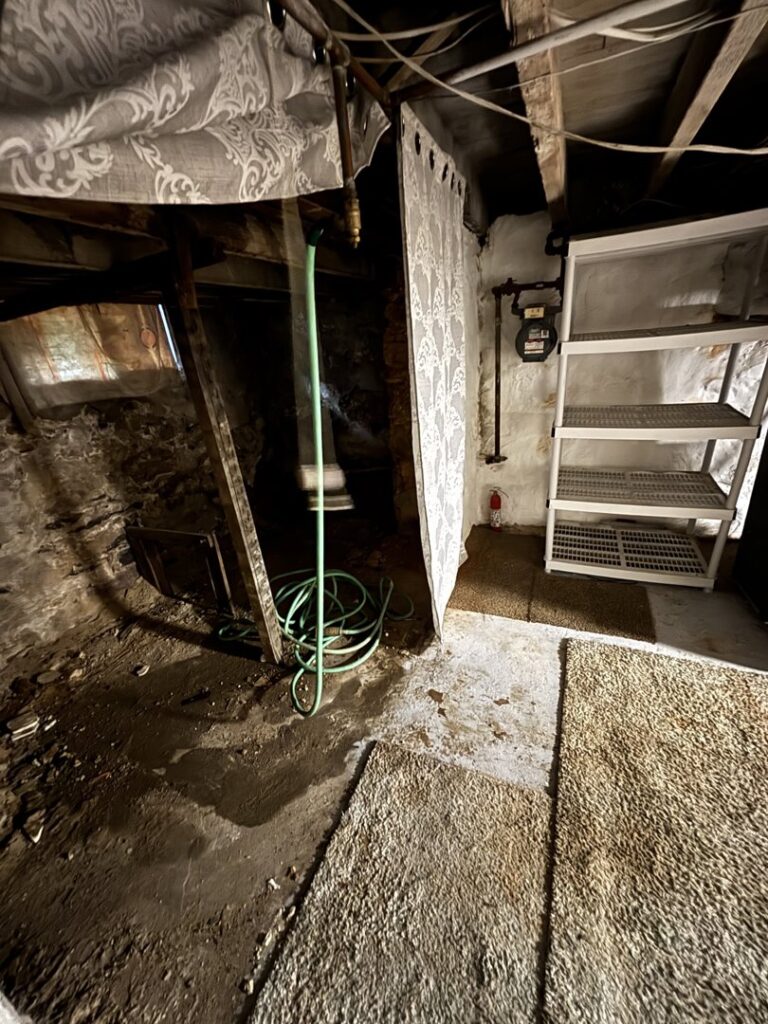 A cluttered basement area needing a cleanout service from GEF Hauling and Junk Removal in Philadelphia, PA.