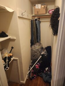A cluttered closet filled with clothes and boxes, ready for cleanout by Master Junkers in Powell, OH.