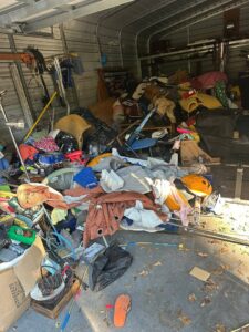A cluttered garage filled with various items, ready for junk removal by Bring That Junk Removal and Demolition in Jacksonville, FL.