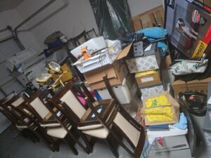 A cluttered garage filled with various items, ready for junk removal by Power Haulers & Junk Removal LLC in Phoenix, AZ.