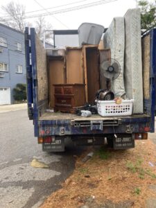 A cluttered garage full of items awaiting junk removal by We Love Junk in Philadelphia, PA.