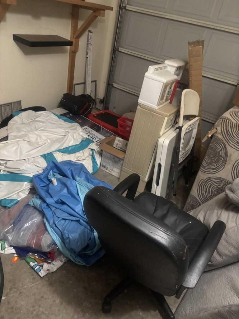 A cluttered garage filled with various household items and debris before junk removal by Silverhull Junk Removal in San Antonio, TX.