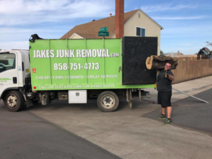 A cluttered garage filled with various items and junk ready for removal by Jake's Junk Removal in San Diego, CA.