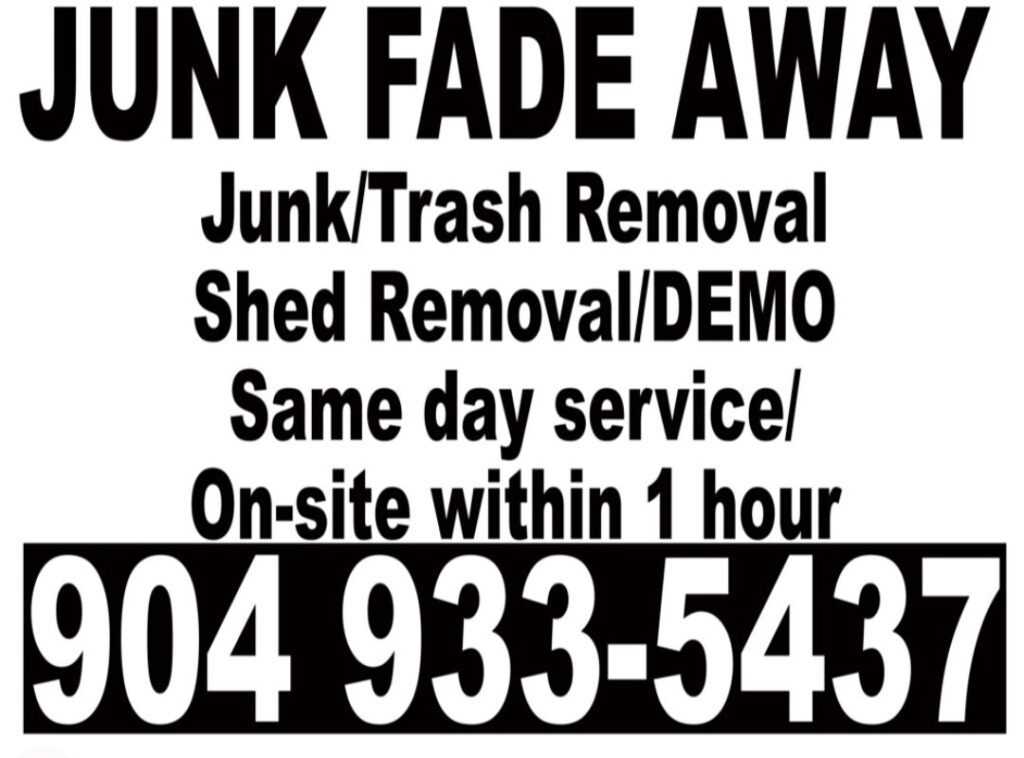 A cluttered room with a table piled with boxes and trash bags, ready for cleanout by Junk Fade Away, LLC in Jacksonville, FL.