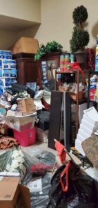 A densely packed and cluttered room with boxes and household items, indicating a cleanout job for All Needz Junk Removal & Hauling Service in Dallas, TX.