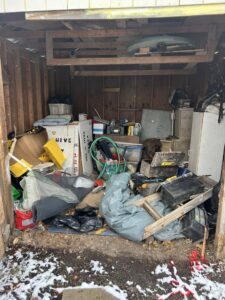 A cluttered shed filled with various junk items before a cleanout service by JDog Junk Removal & Hauling in Columbus, OH.