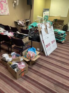 A room filled with cardboard boxes and trash, indicating a commercial or office cleanout job for Cee J Junk Removal LLC in Phoenix, AZ.