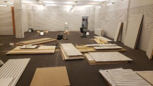 An empty commercial store space with disassembled shelving and fixtures on the floor, ready for cleanout by J & R Junk Removal in Phoenix, AZ.
