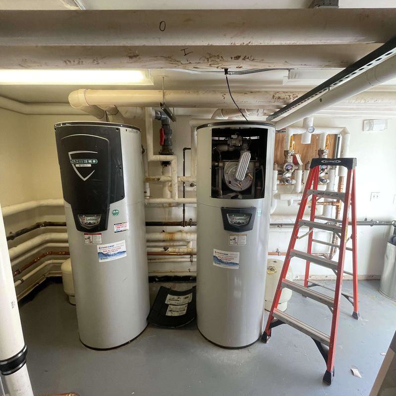 Two large commercial water heaters installed with visible plumbing by Molberg Plumbing in Ft Worth, TX