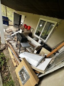 A large pile of construction debris and old furniture on a patio for removal by S&M Junk Removal in Philadelphia, PA.