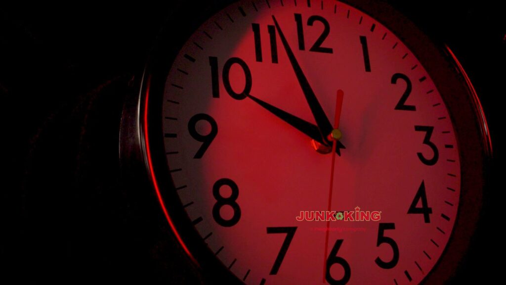 A pile of construction debris, including doors and wood, next to a Junk King San Antonio Northwest truck in San Antonio, TX.