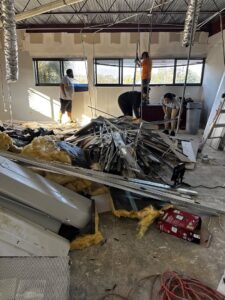 A large pile of construction and demolition debris inside a commercial building for removal by DUMP 4 U Hauling in Jacksonville, FL