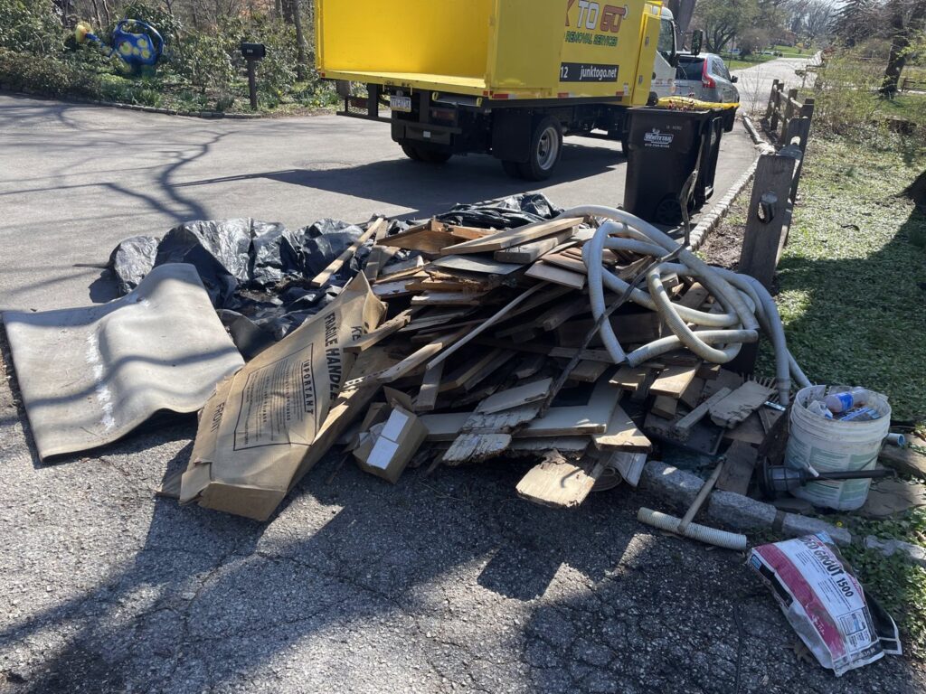 A pile of construction debris including wood and pipes awaiting removal by Junk to Go in Philadelphia, PA.