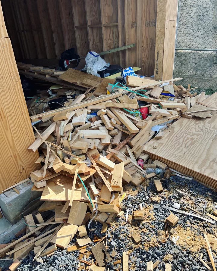 A large pile of wood scraps and construction debris inside a shed, ready for cleanout by JUNK BOX LLC in Philadelphia, PA.