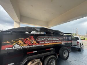 A covered trailer full of junk ready for transport by Speedy Junk Removal & recycling in Houston, TX.