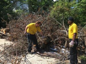A Junk Doctors of Charlotte crew removing a large pile of yard waste and branches in Charlotte, NC.