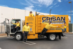 The Crisan Junk Removal team posing with their branded truck, ready for service in San Diego, CA.