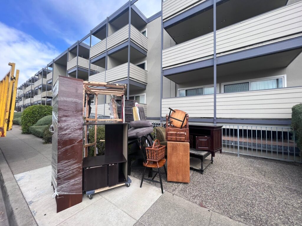 A curbside pile of appliances, bicycles, and general junk awaiting pickup by Zero Junk in San Jose, CA.