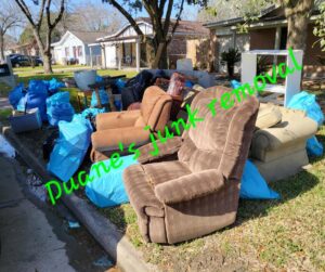 Old recliners, couches, and blue trash bags piled at the curb, awaiting general junk removal by Duane's junk removal LLC in Houston, TX.