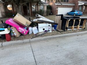A large pile of household junk and debris placed curbside for removal by 1-800-GOT-JUNK? in Fort Worth, TX.