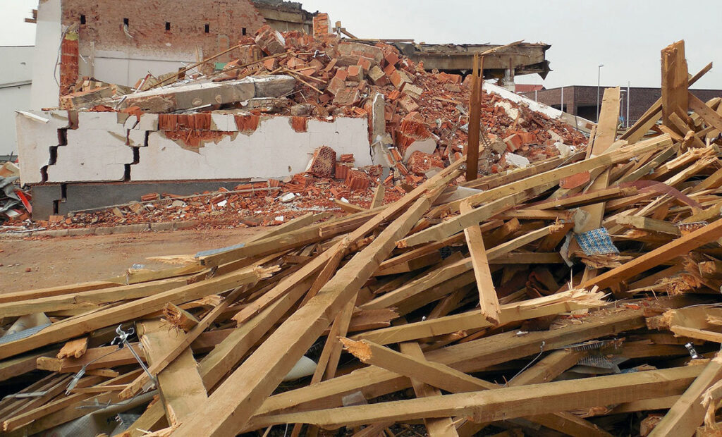 A large pile of demolition rubble and wooden debris from a building, ready for removal by Zen Junk in San Jose, CA.