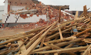 A large pile of demolition rubble and wooden debris from a building, ready for removal by Zen Junk in San Jose, CA.