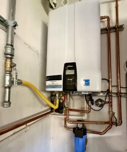 A detailed view of a tankless water heater and water filtration system installation by JG Water Heaters, Filtration and Plumbing in San Diego, CA