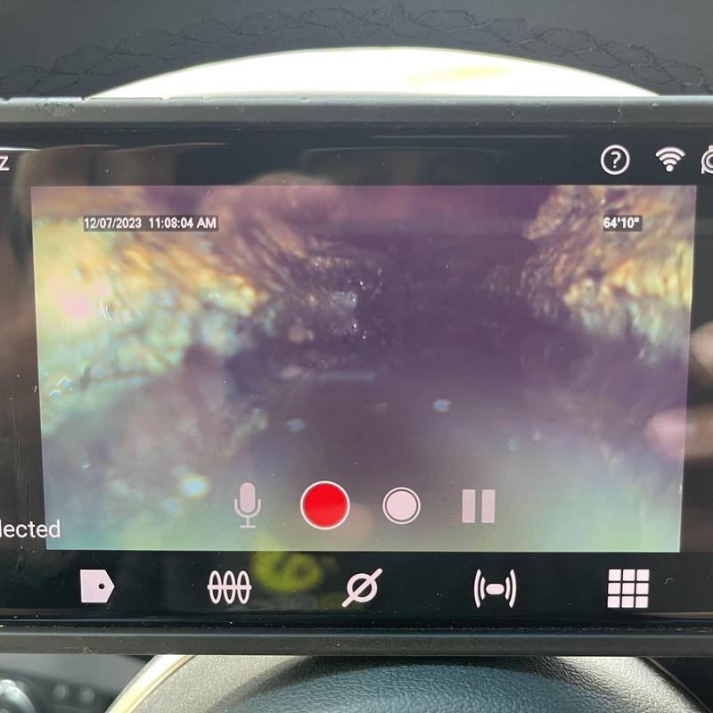 A screen showing a drain camera inspection video, used by Tribeca Plumbing for sewer line diagnostics in Dallas, TX.