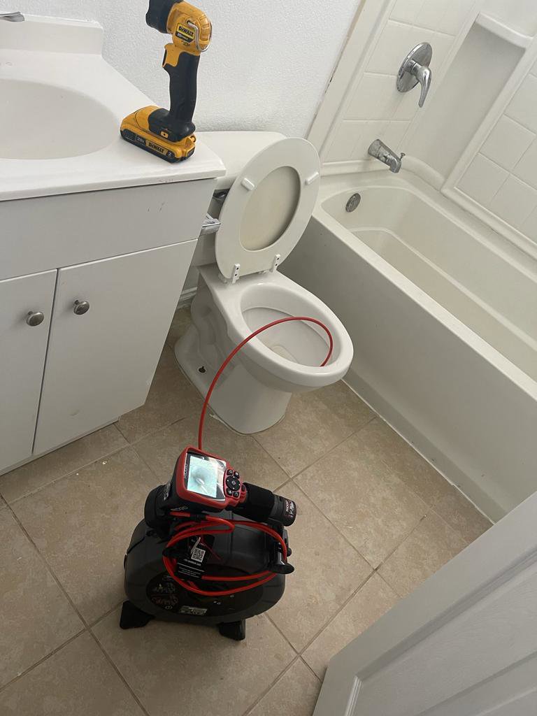 A drain camera being used for a toilet inspection by Plumbing Services Inc. in San Diego, CA.