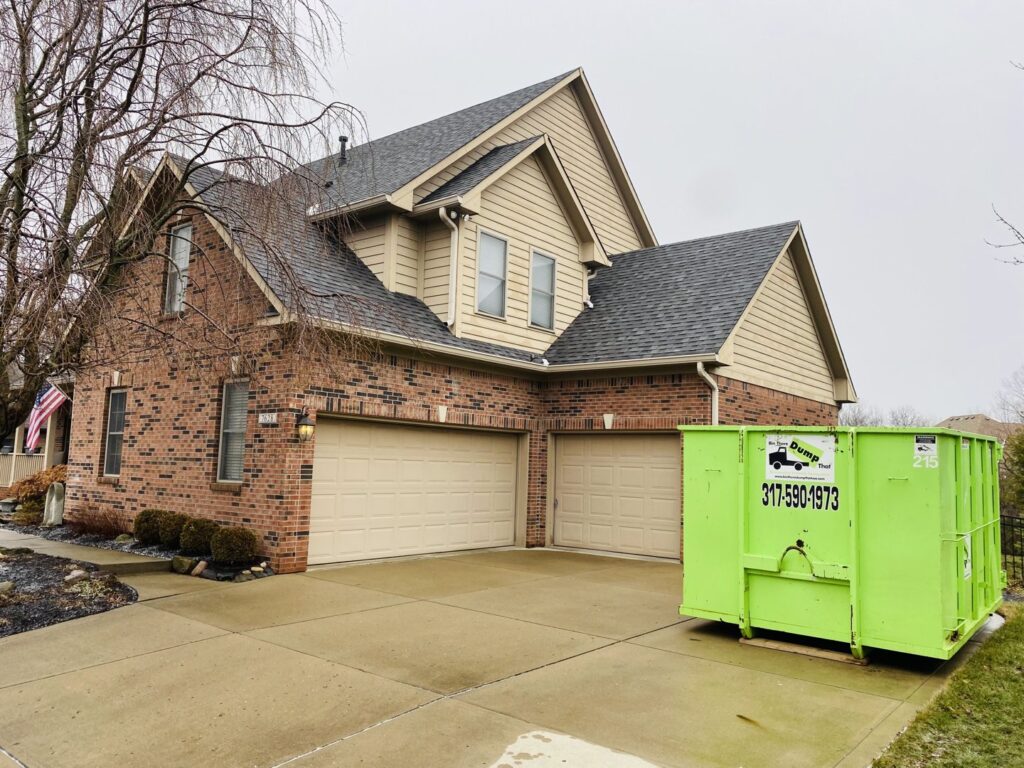 A Bin There Dump That green dumpster on a residential driveway, perfect for general junk removal in Indianapolis, IN.