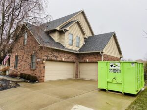 A Bin There Dump That green dumpster on a residential driveway, perfect for general junk removal in Indianapolis, IN.