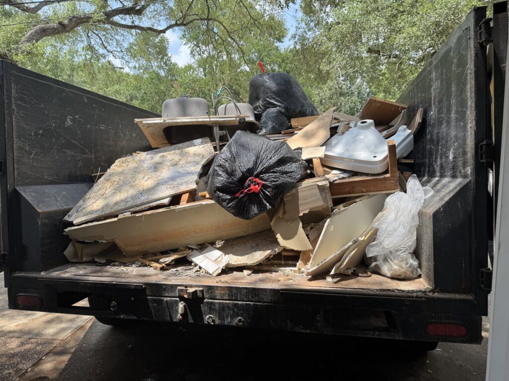 A dump trailer filled with construction debris and trash from a junk removal job by Speedy Junk Removal & recycling, Houston, TX.