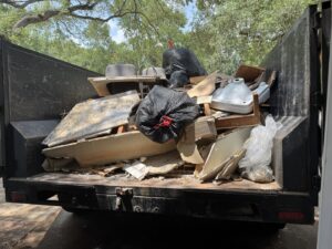 A dump trailer filled with construction debris and trash from a junk removal job by Speedy Junk Removal & recycling, Houston, TX.