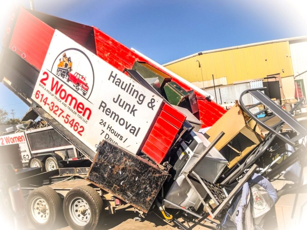 A dump trailer from 2 Women with a Pickup Truck and Trailer Too LLC unloading appliances and various junk at a disposal site in Columbus, OH.